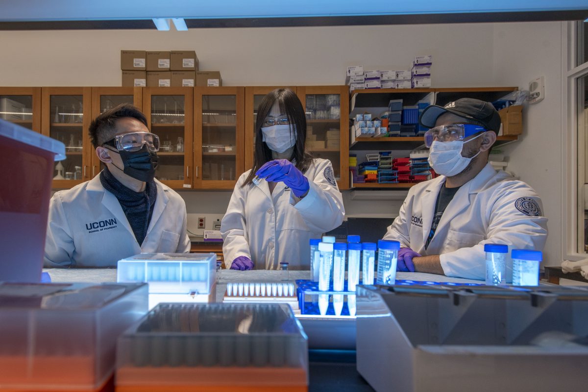 Xiuling Lu with graduate students at her lab in the School of Pharmacy. Jan. 26, 2022. (Sean Flynn)